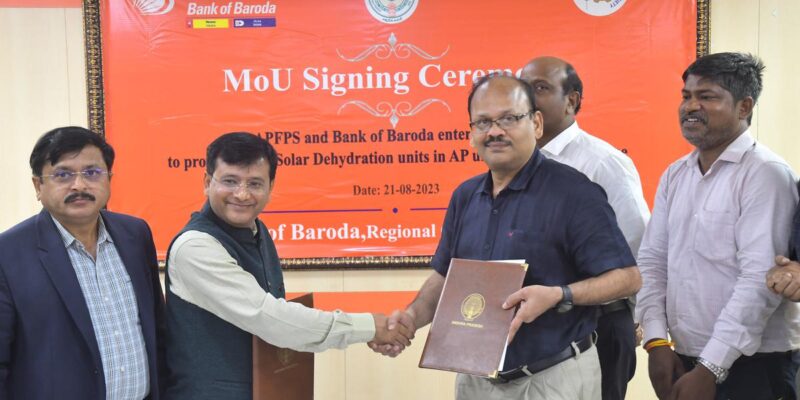 AP Food Processing Society CEO L. Sridhar Reddy and Bank of Baroda DGM Chandan Sahoo at the signing of an MoU for expansion of solar dehydration units, in Vijayawada on Monday